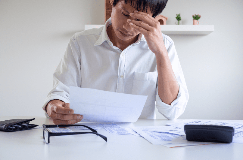 sad man looking at documents