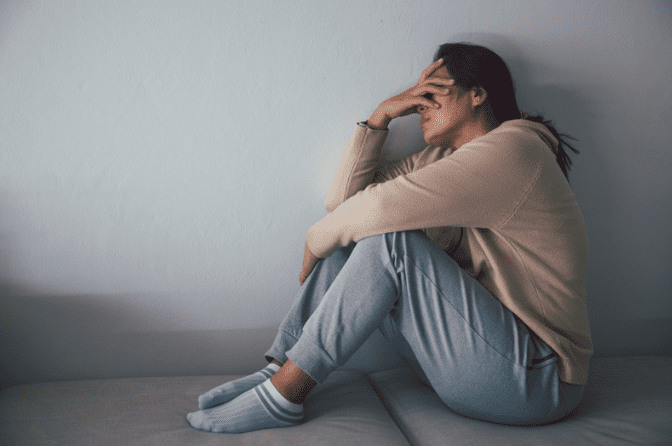 An Asian woman feeling sad