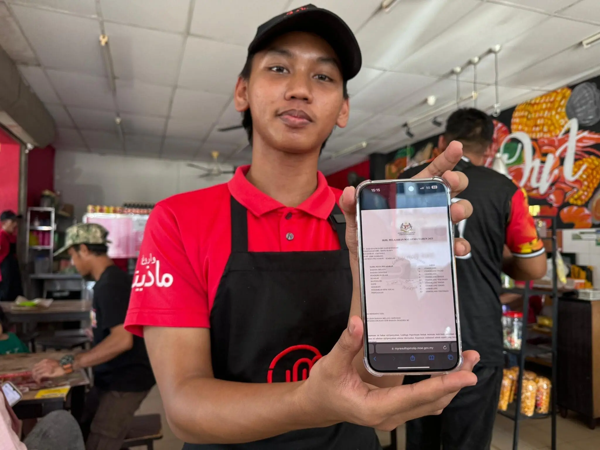 Said Syazwan Said Rosnizam showing his SPM results