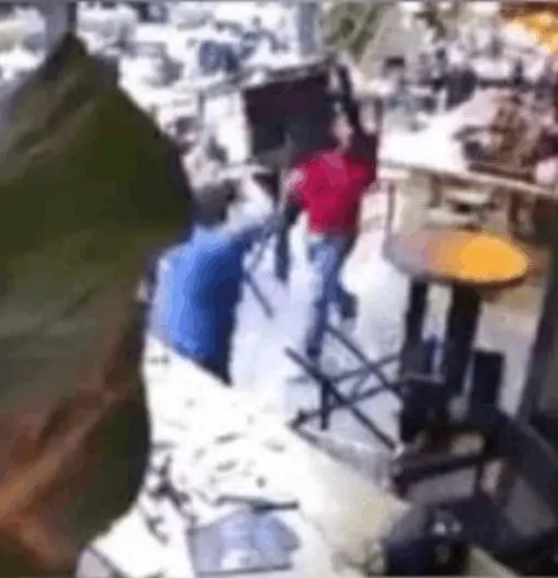 Three men hurling chairs at each other