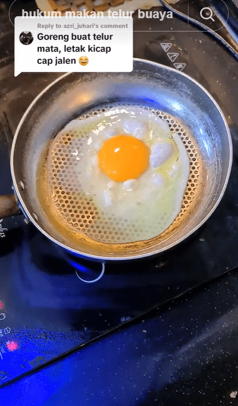 Malaysian man frying crocodile egg