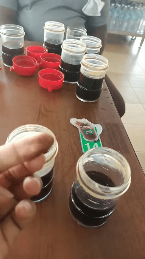 Woman showing what is suspected to be mold in the soy sauce container
