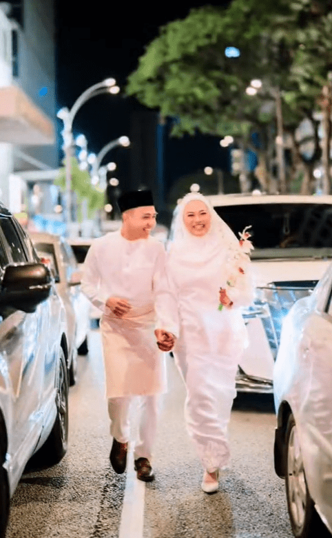 Newlyweds walking along Bukit Bintang zebra crossing