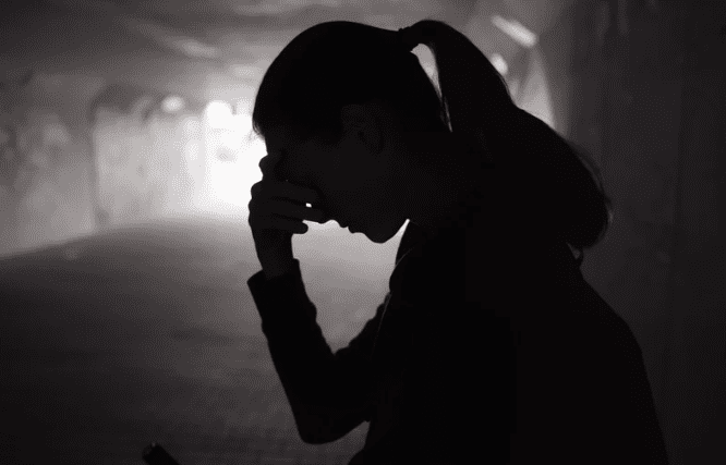 Woman covering her face