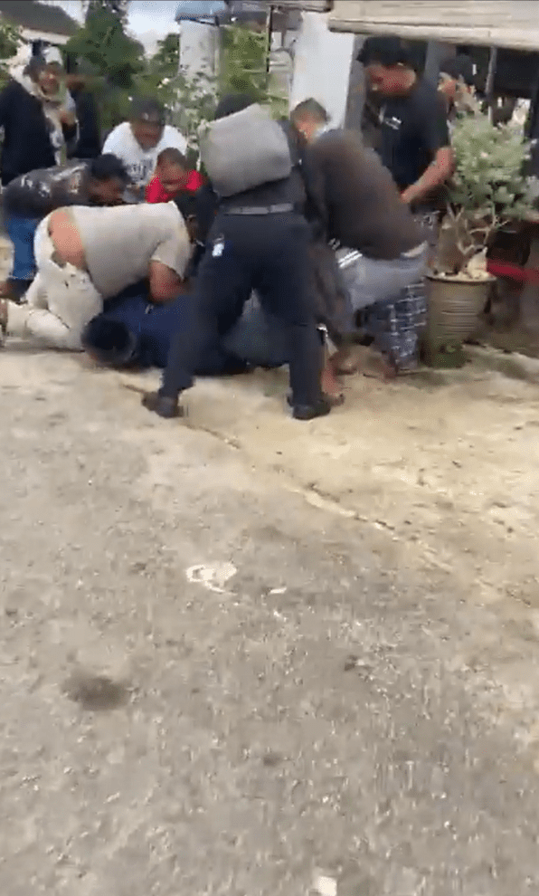 Passersby surrounding and apprehending Nepali man
