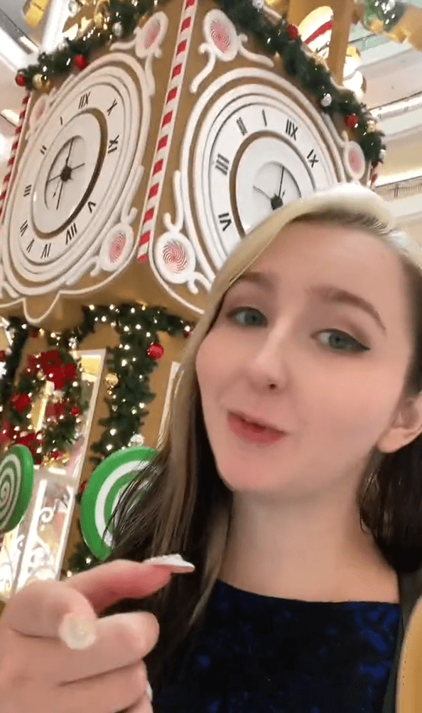 US woman with Christmas clock tower behind her