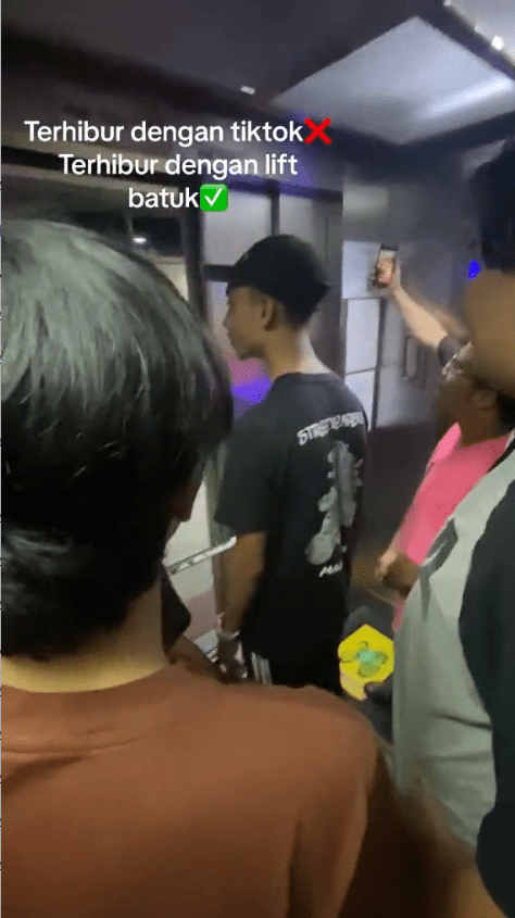 M'sian students waiting for the lift to close its door, while some ready with their phone to record the moment.