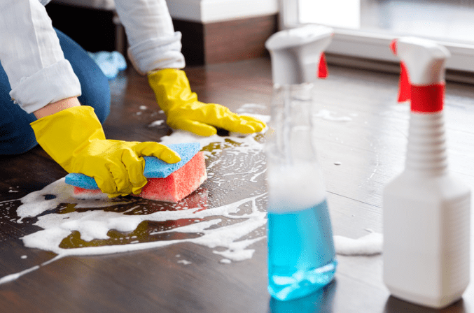 Woman scrubbing the floor with soap