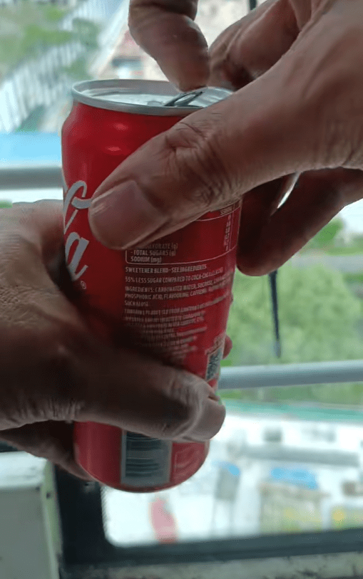 SG man drinks a can of Coke
