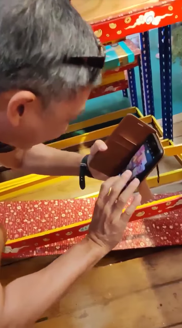 SG man takes a photo of broken shelf at Mid Valley Southkey