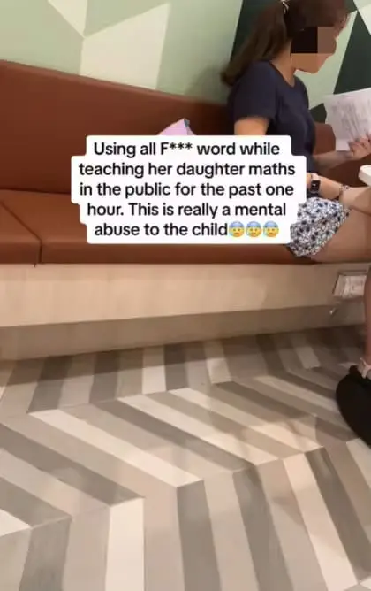 SG woman holding daughter's Math homework