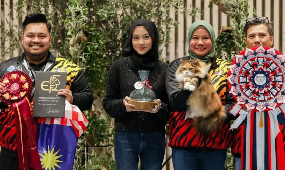 Shaharudin and Rooaida, along with their cat, Baby.