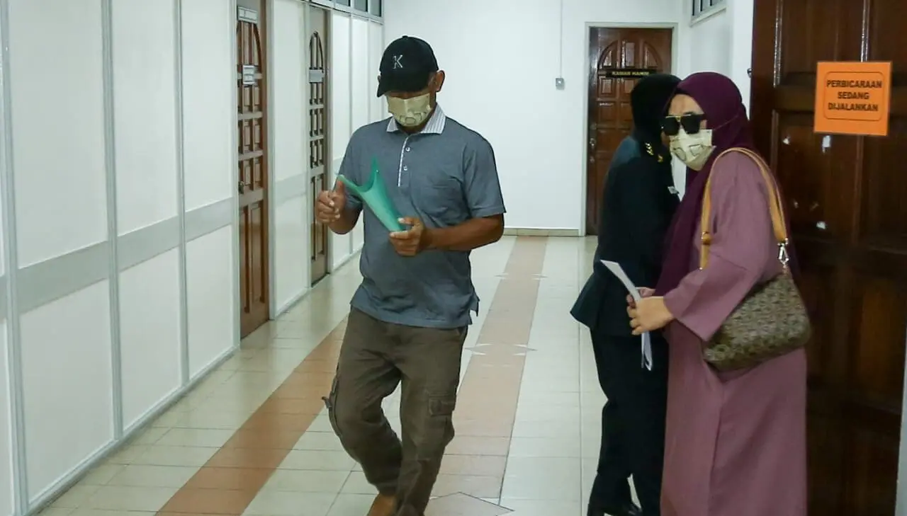 Sharuddin Saidon walking out from the courtroom