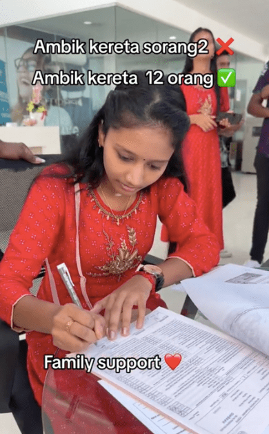 Malaysian girl filling in the forms for the car purchase 