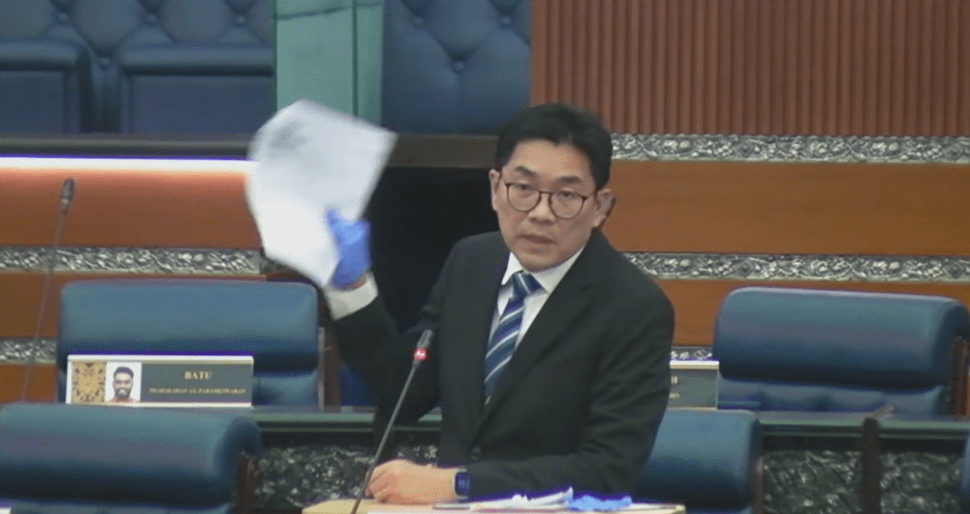 Sim Tze Tzin shows patient's hospital bill