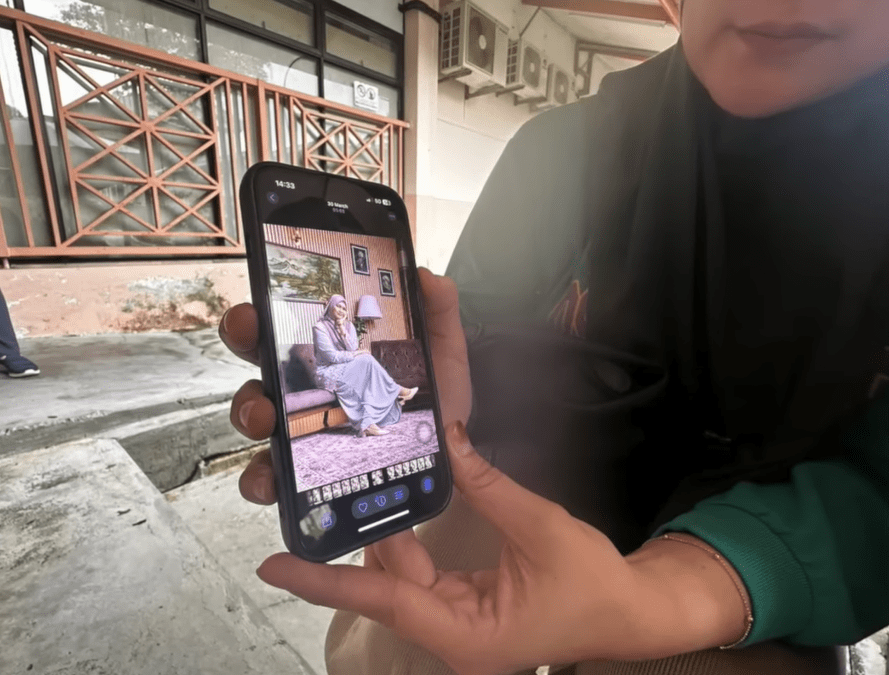 Siti's relatives showing a photo of her