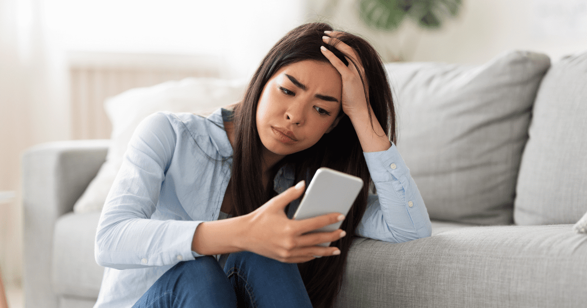 stressed woman looking at phone