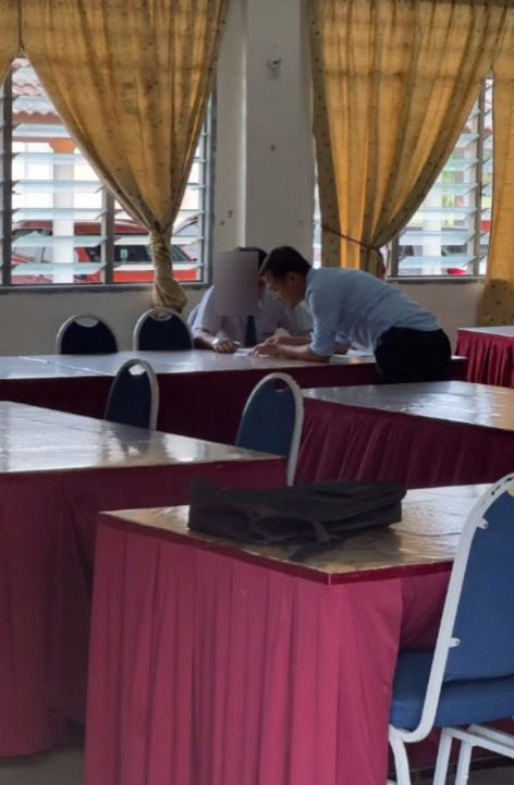 student and teacher inside exam hall