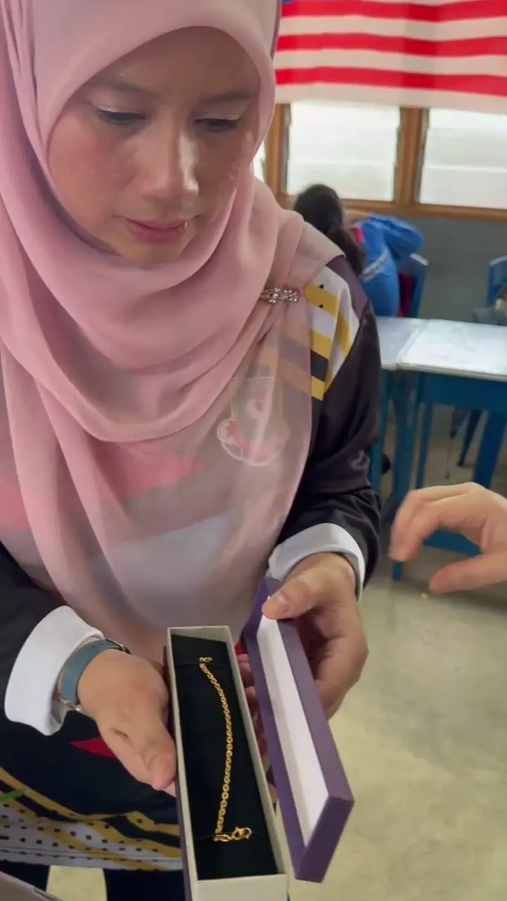 teached stunned by the gift presented by her students