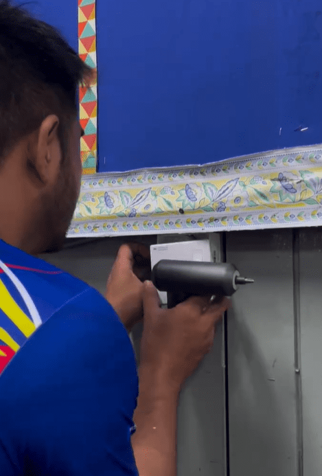 Teacher installing fan for classroom Screenshot 2025-02-24 142703
