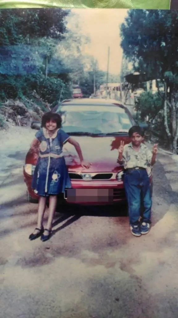 teacher jaslene and family member posing with a car