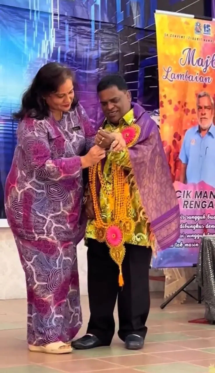 Teacher wearing a watch to Uncle Mano at his farewell event