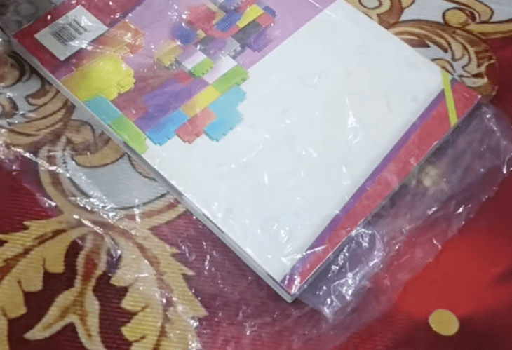 textbook wrapped with plastic bag