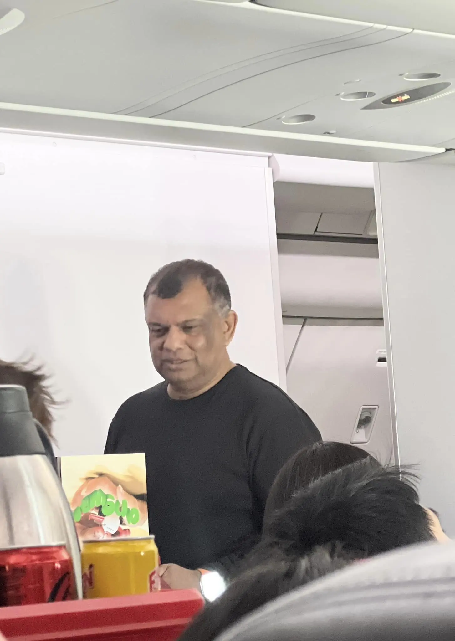 Tony Fernandes serving passengers on a flight back from Hokkaido
