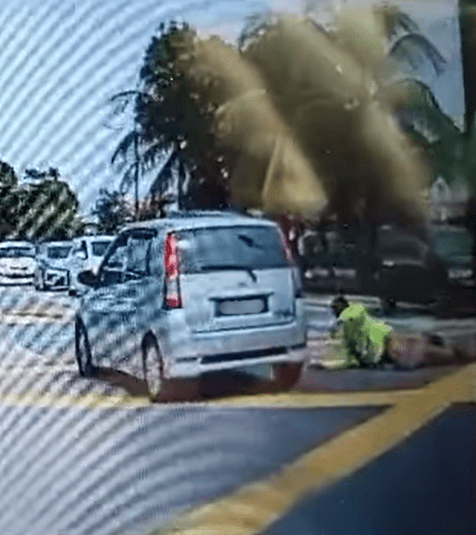 Traffic warden on the ground after getting hit by car