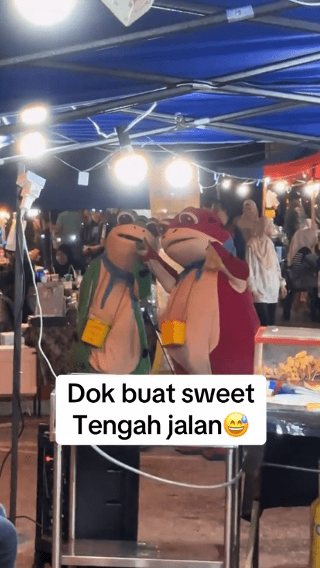 two frog mascots giving peace pose