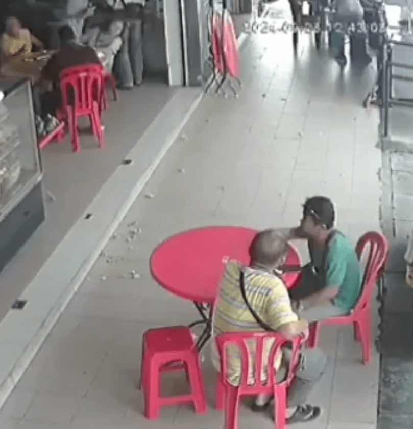 two men sitting at a kopitiam