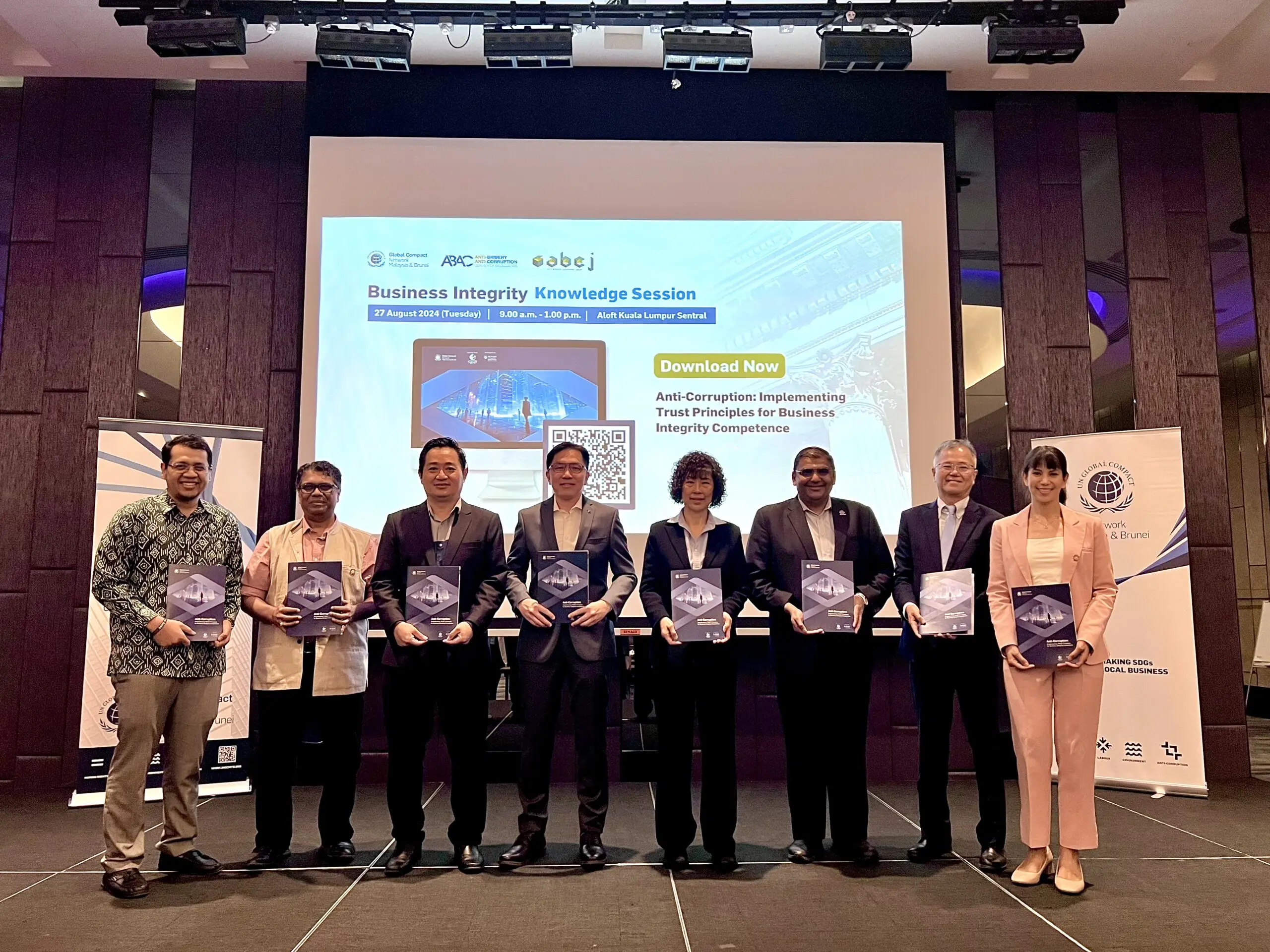“UNGCMYB leaders and partners proudly display the newly launched _Malaysian Companies Best Practices in Business Integrity and Anti-Corruption_ case studies during the Business Integrity Knowledge Session