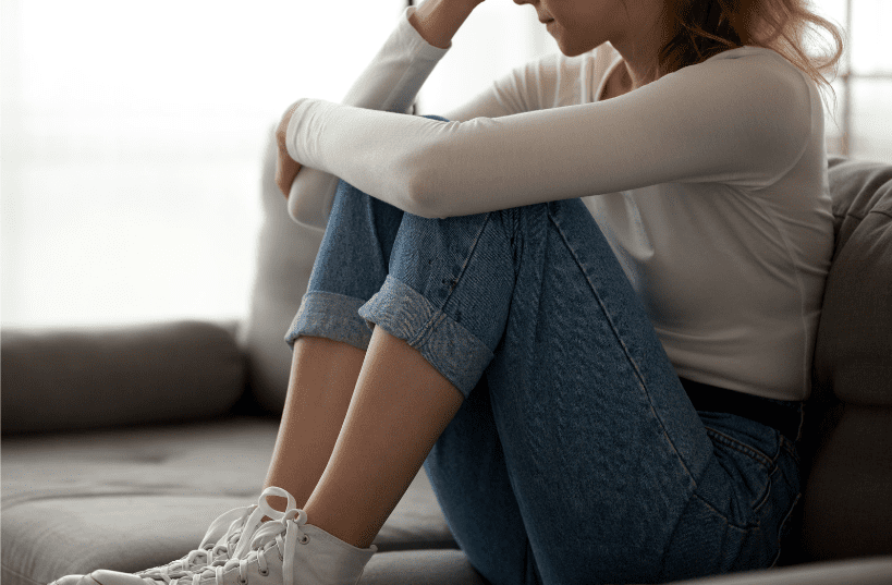 Upset woman sitting on the couch