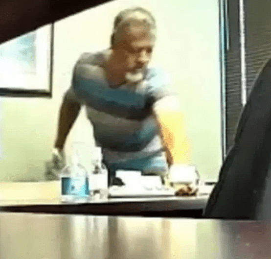 Lucio Catarino Diaz peeing into bottle