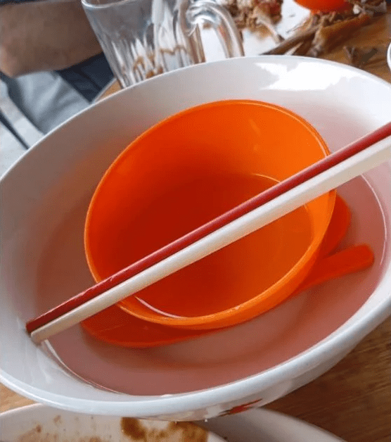 Utensils being washed in hot water