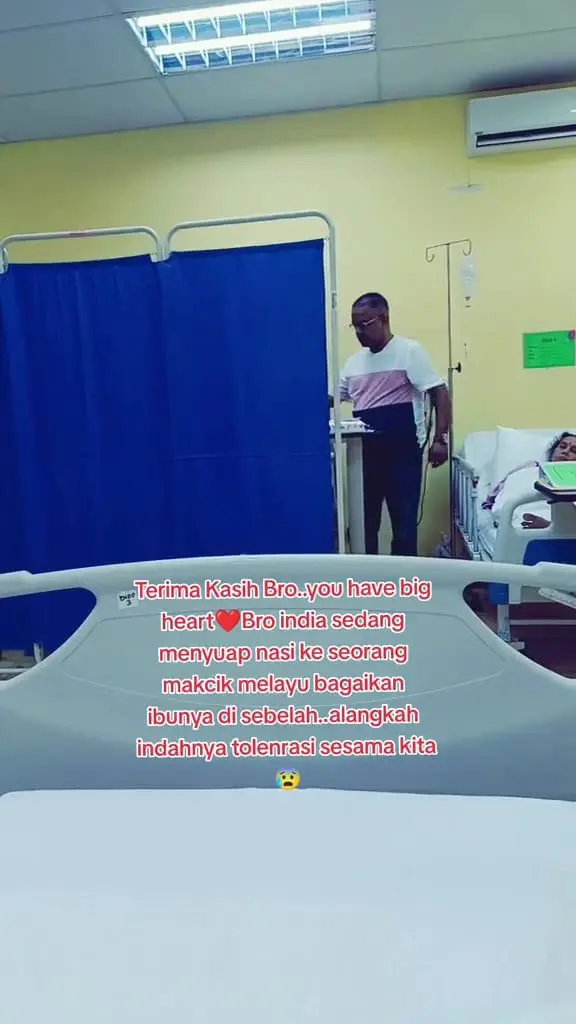 Msian man helping another patient in a hospital