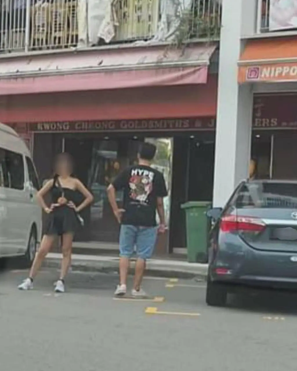 msian woman standing at an empty parking spot reserving for her friend
