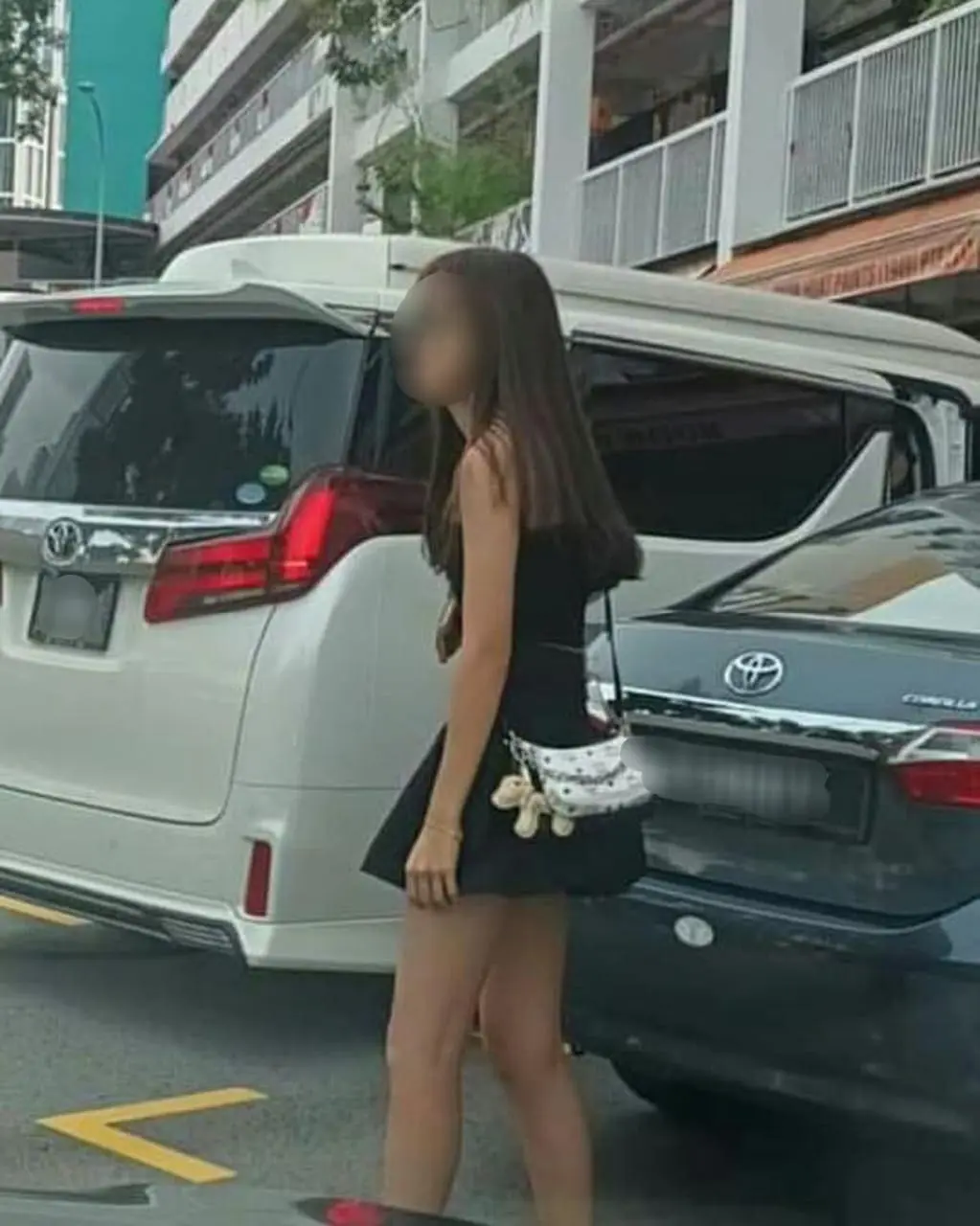 msian woman waiting for her after she chups the empty parking spot