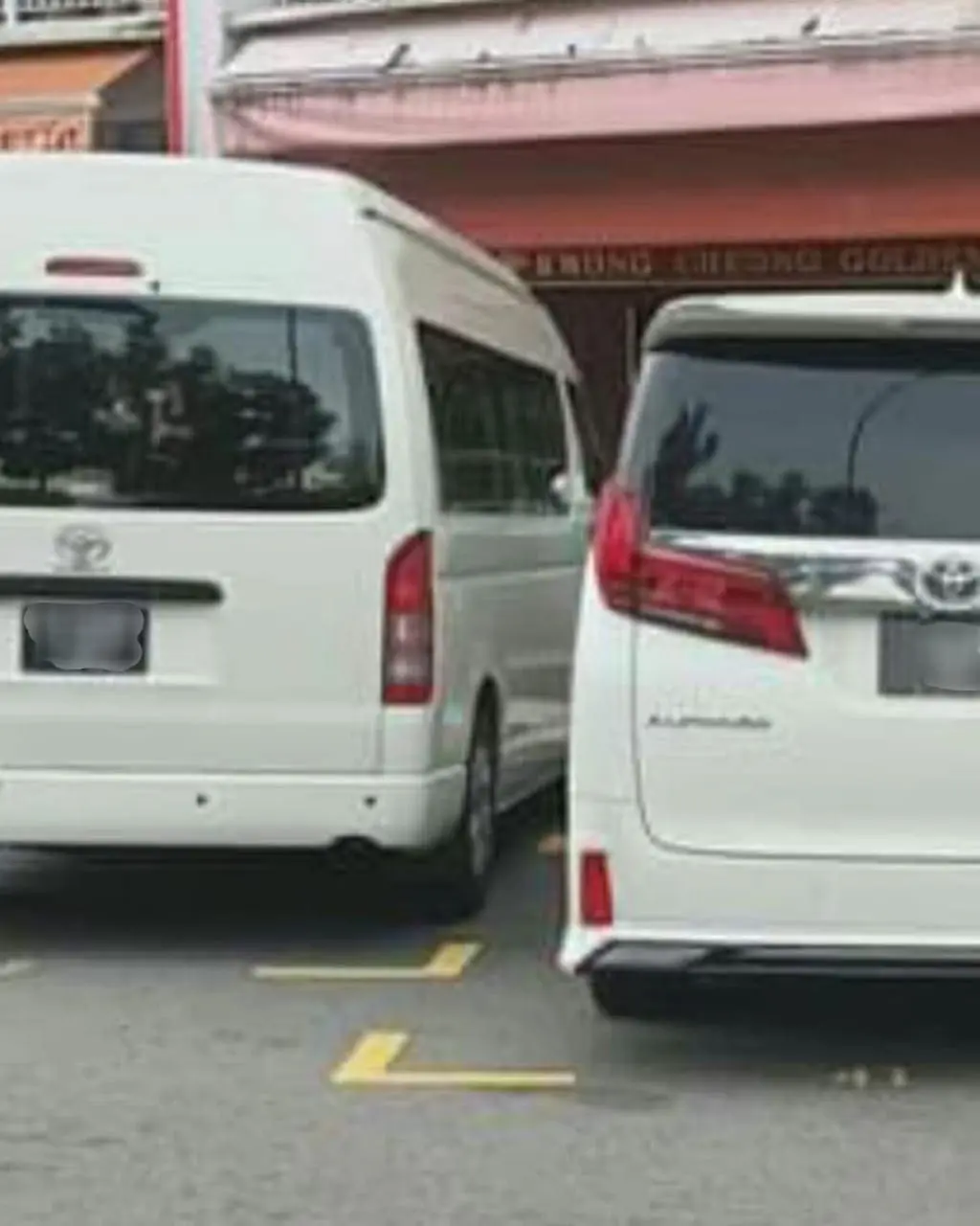 a white car parked beside another vehicle