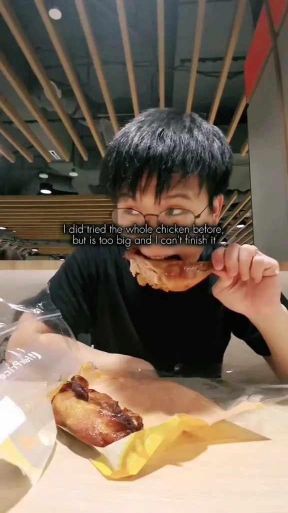 man eating chicken for his dinner