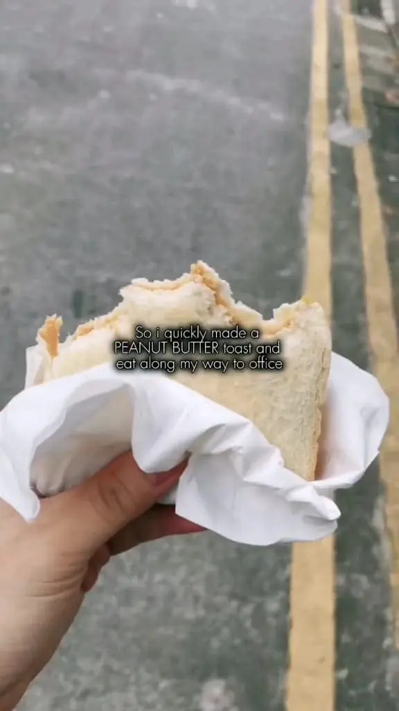 man showing a half eaten peanut toast