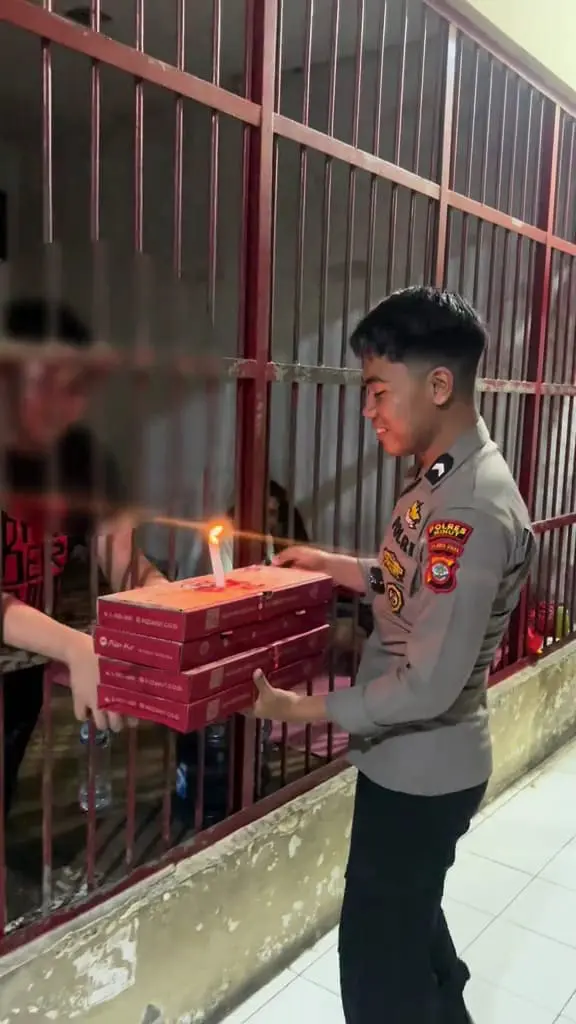 prison guard surprising inmate with pizza during his birthday