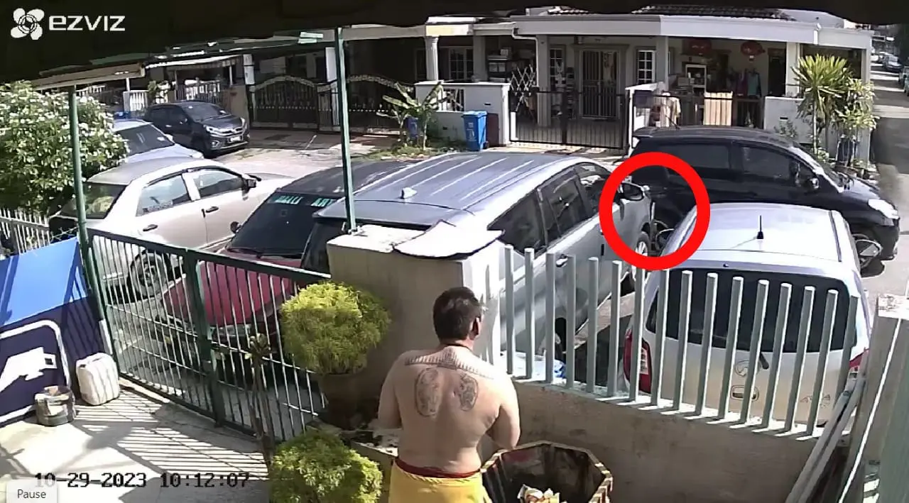 A black Myvi hits the Msian man's car.