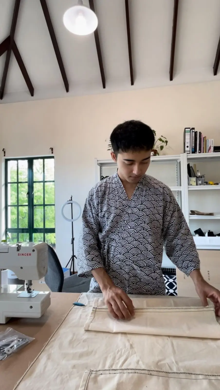 Juju preparing and measuring his Kimonos 