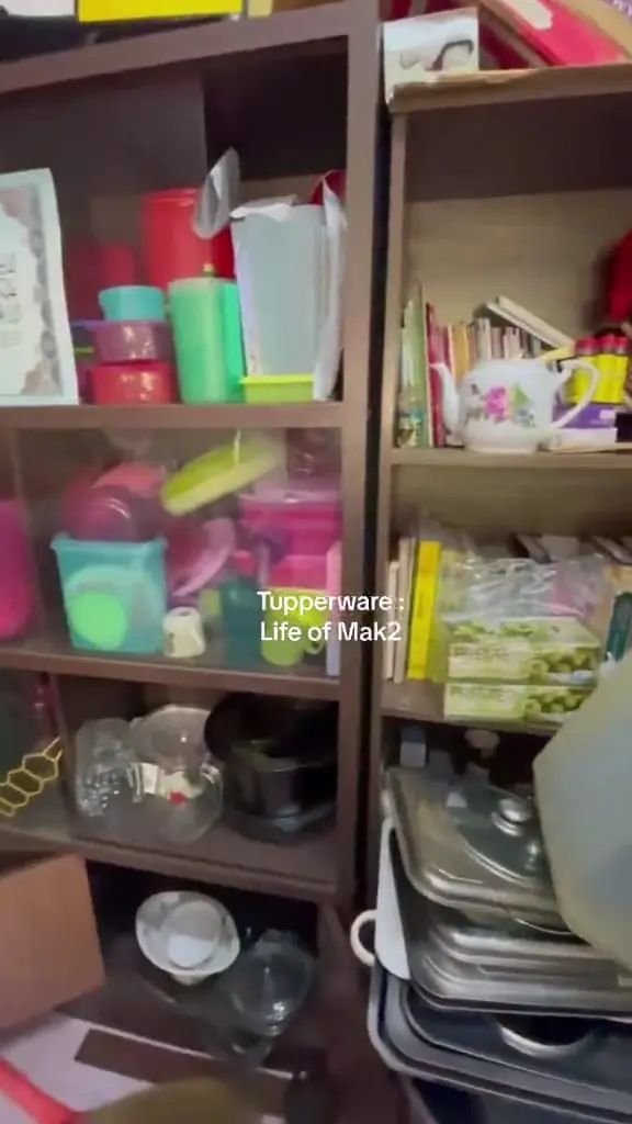 A rack full of unorganized and unused Tupperware collections