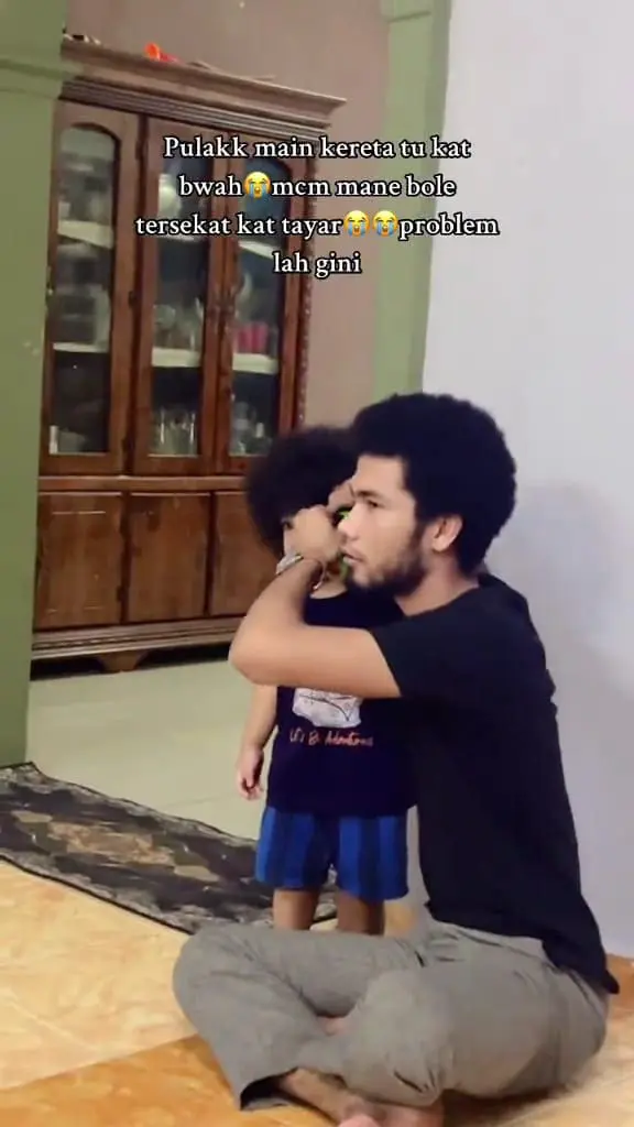 Msian father is trying to removing the car that was stuck into his son's hair.