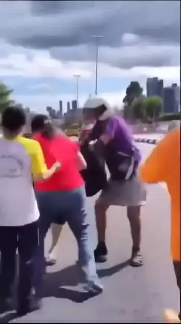 Onlookers trying to spilt the women apart from continuing their fight.