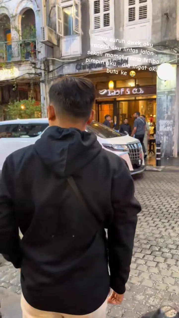 M'sian man preparing to cross the road