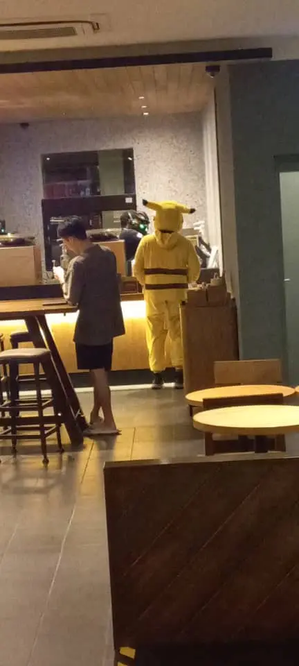 Msian grab food rider waiting to pickup his order at Starbucks store at Port Dickson. 