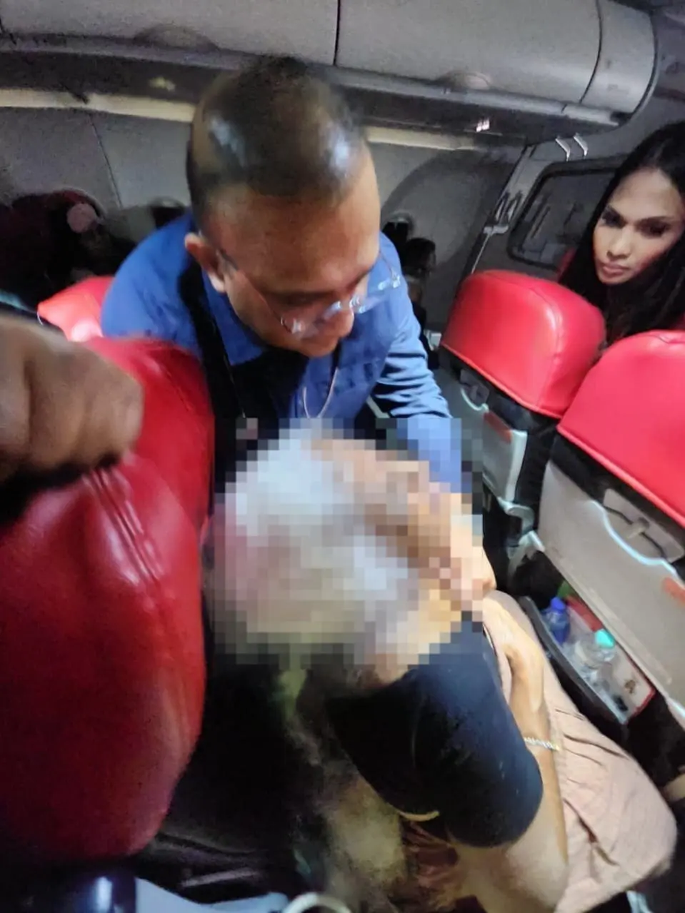 Dr. Sathia Prakash Nadarajan is treating a woman who fainted on a flight in mid-air.